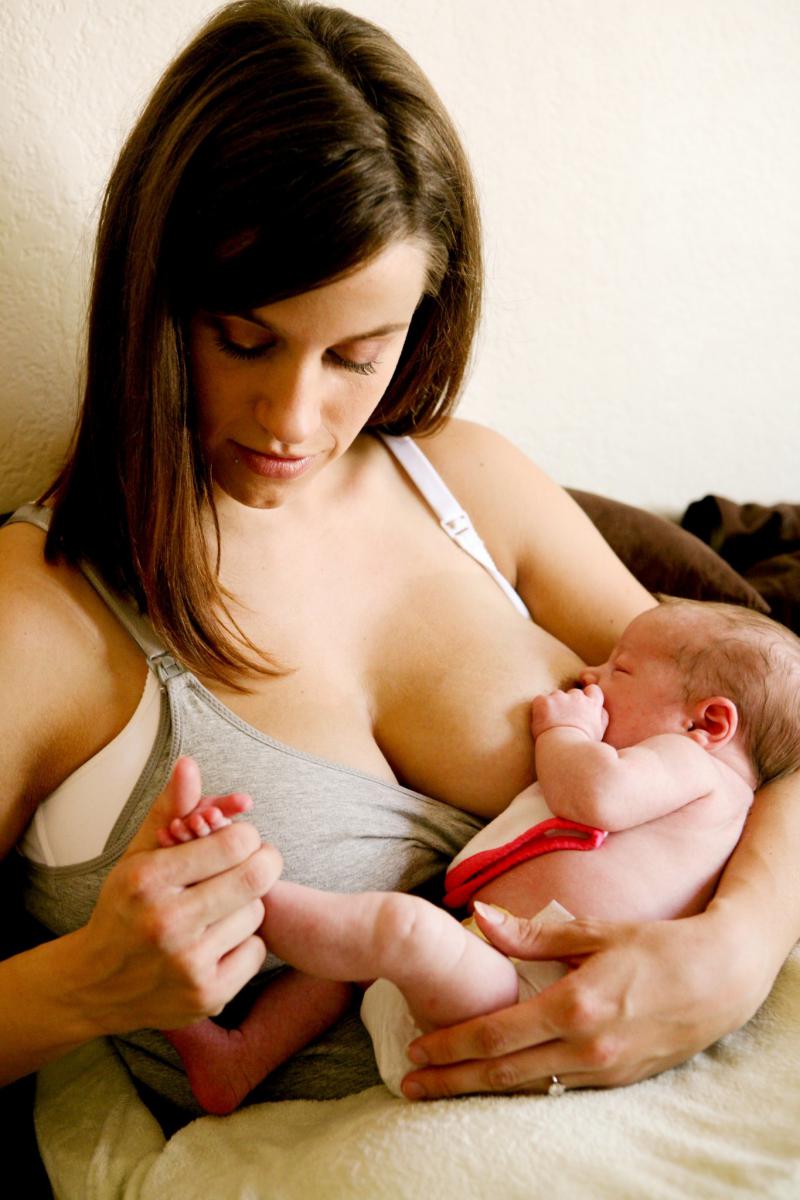 A person breastfeeding a baby.