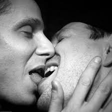 Two persons tounge-kissing.