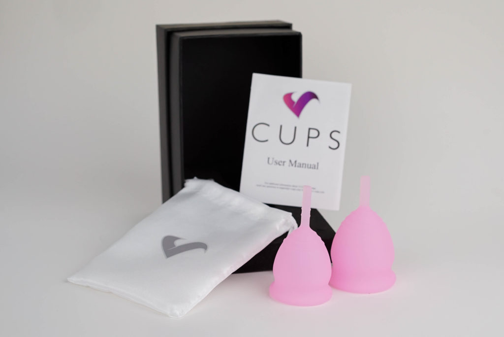 Two pink menstrual cups.
