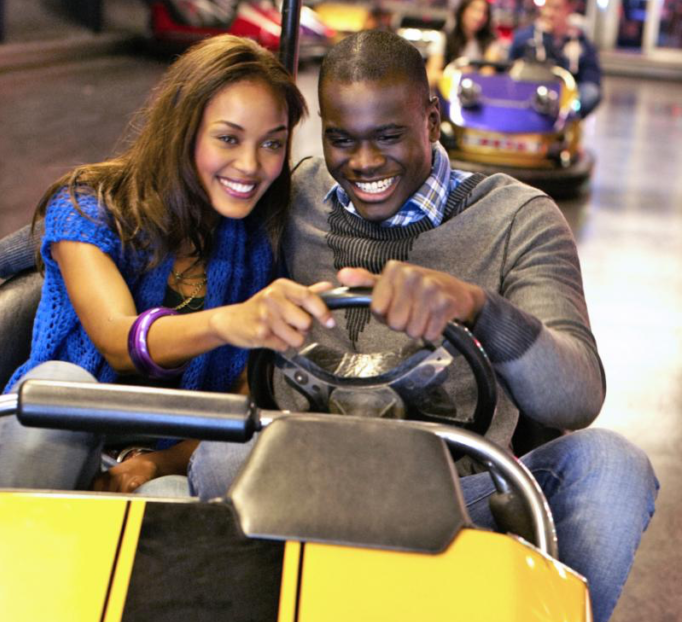 Two people on a go kart. 