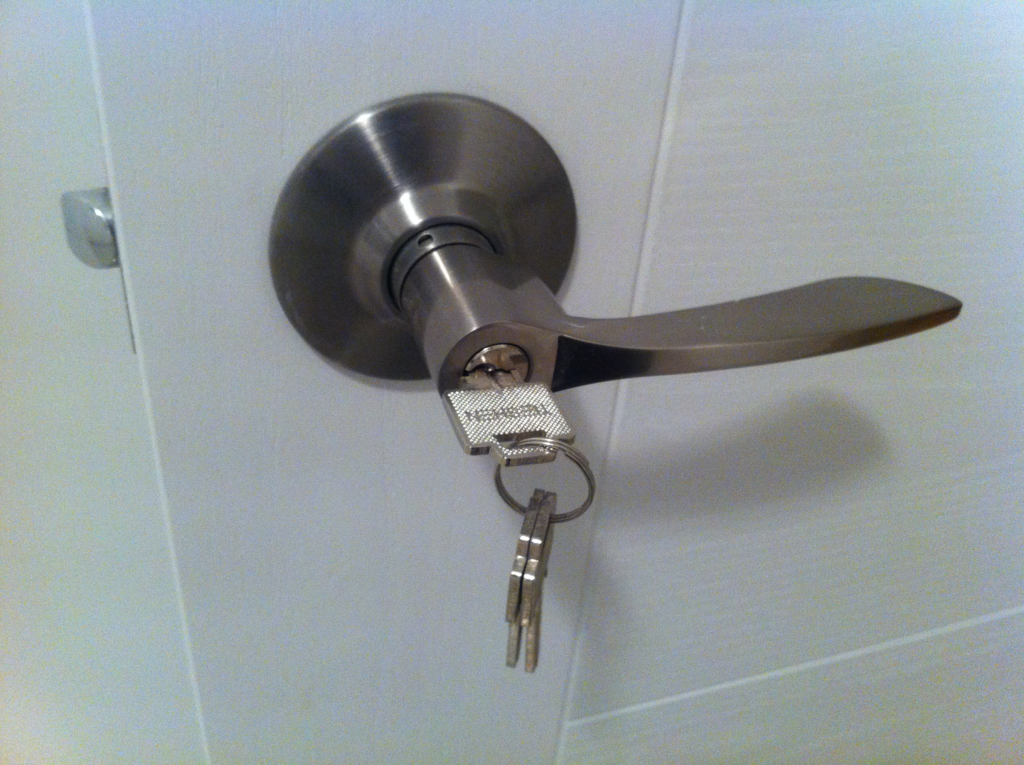 A door handle with keys hanging off it.