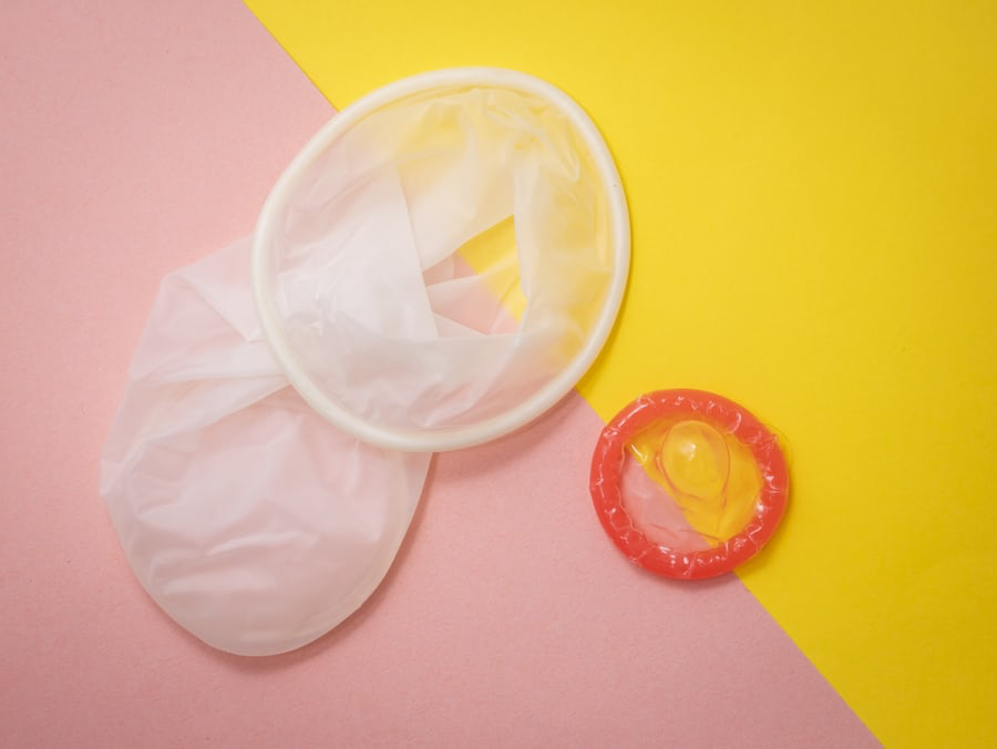 A white condom and a red condom.