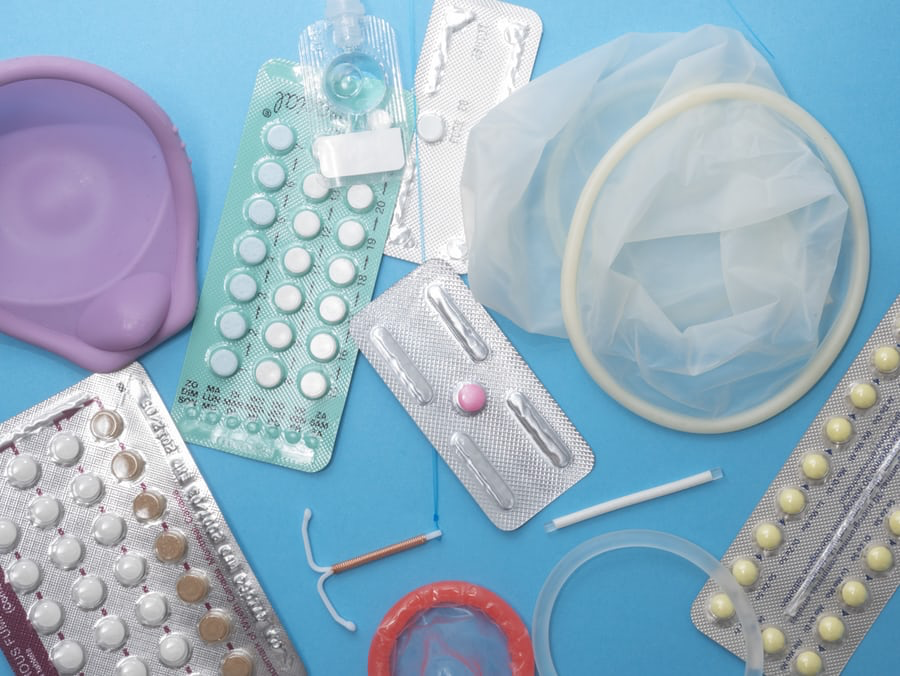 Various contraceptives: condoms, birth control pills, intrauterine device