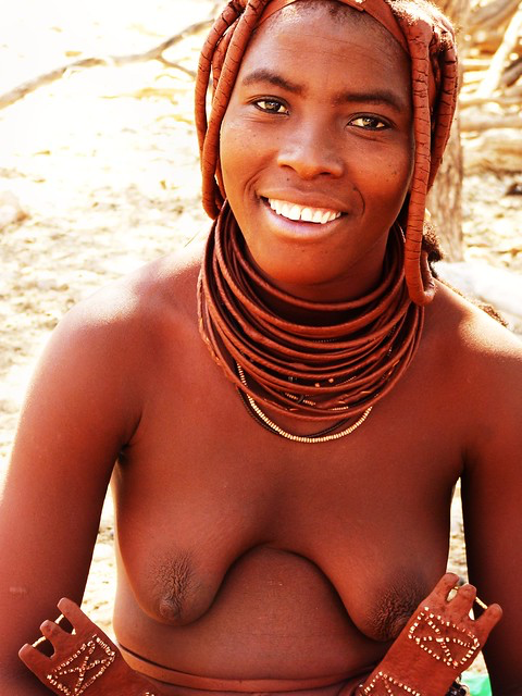 A shirtless tribal woman in tribal braids