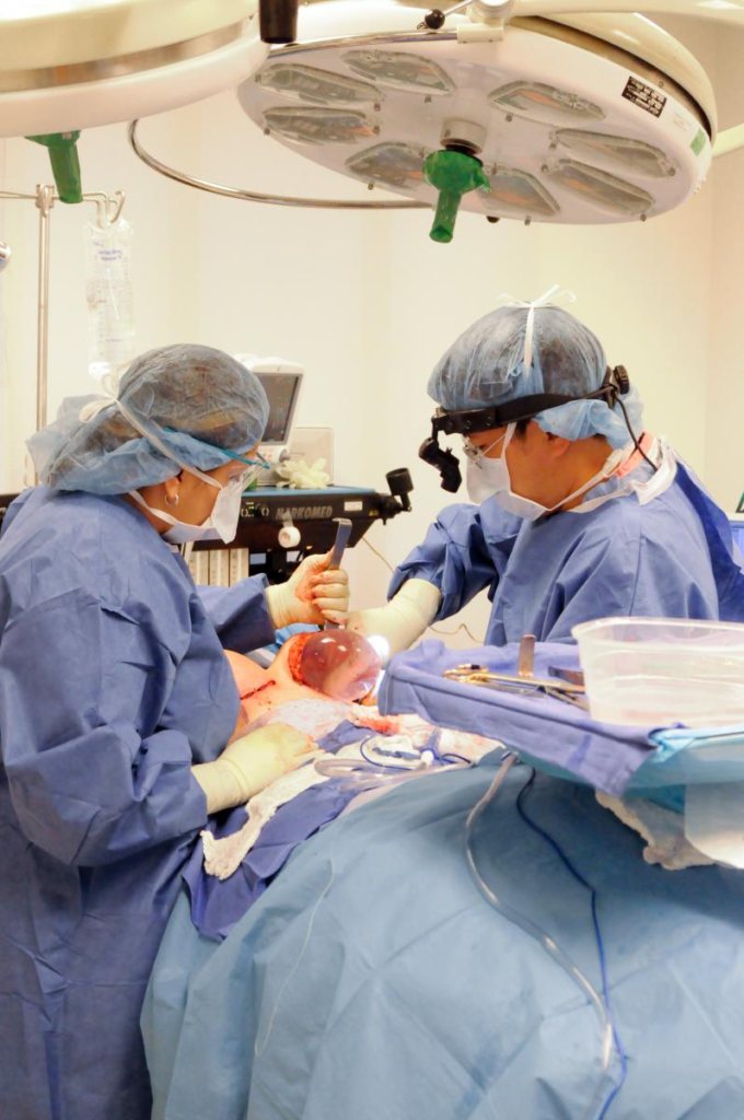 Two surgeons operating on a body, only organs visible