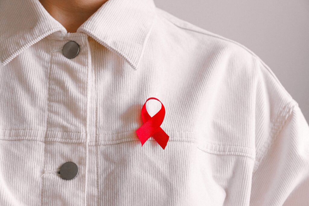 A red ribbon on a white collared top.