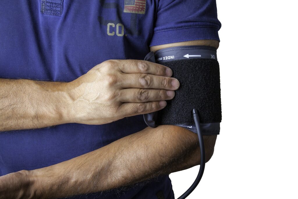 A person's arm wrapped with a sphygmomanometer.