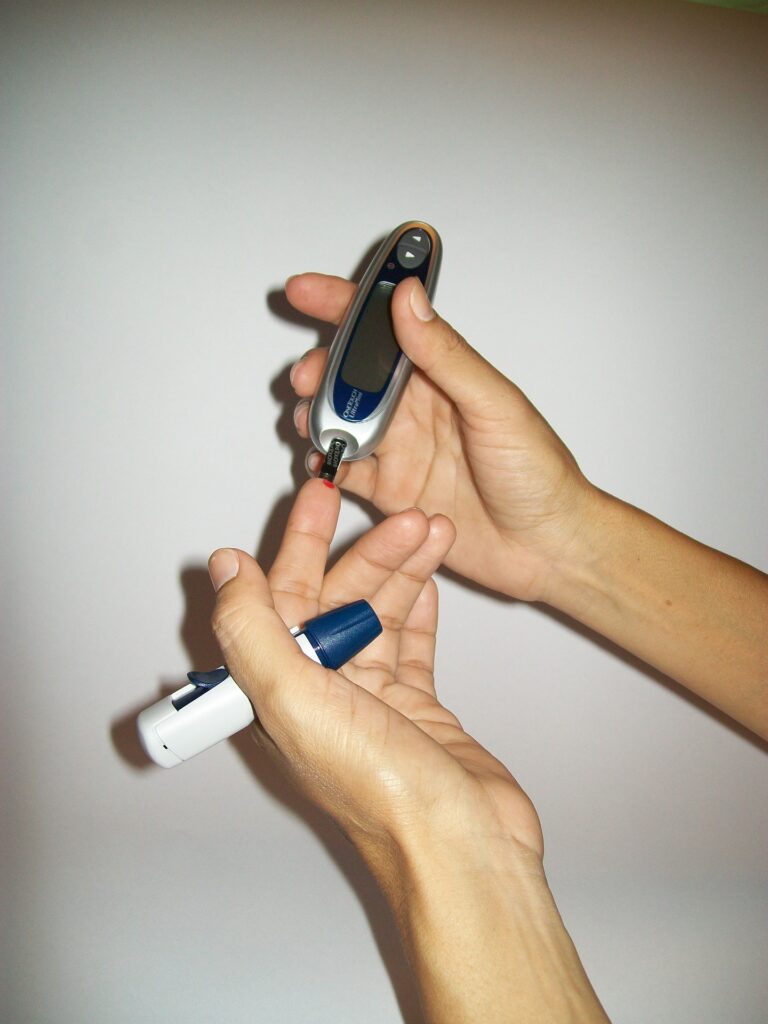 A person poking their finger with a lancet.