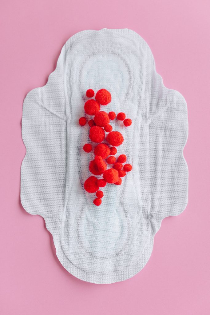 A menstrual pad with red circles on it.
