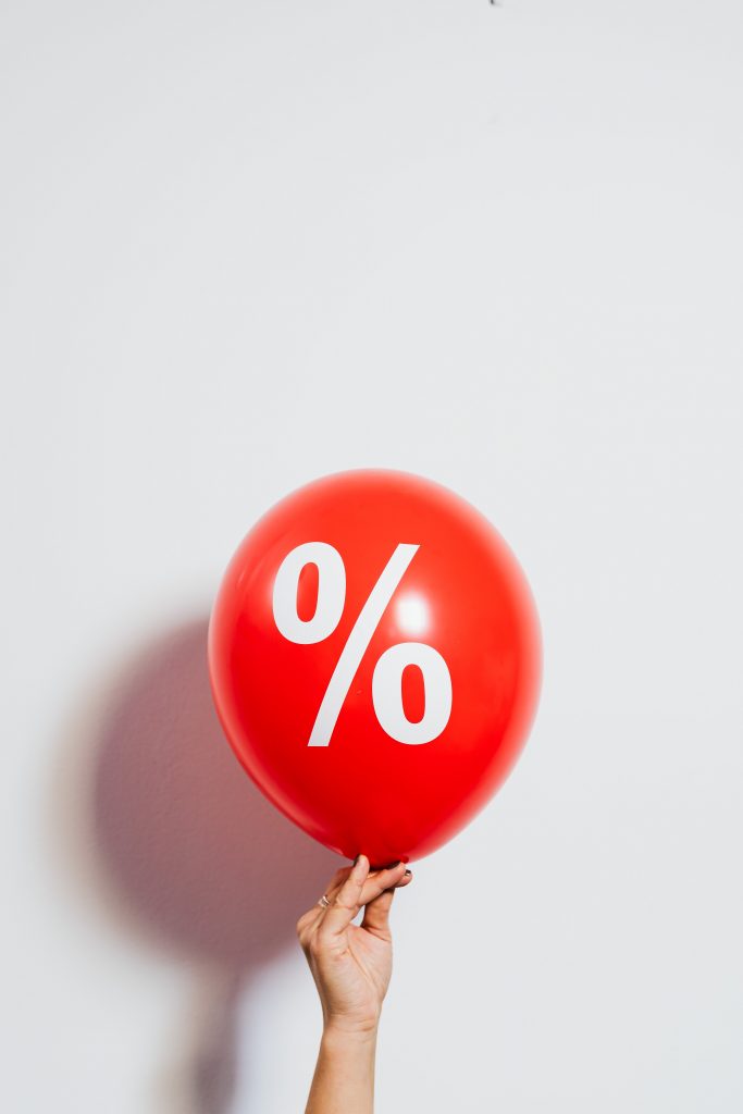 A red balloon with a white percent sign on it.