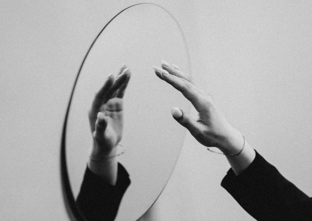 Female hand reaching for mirror