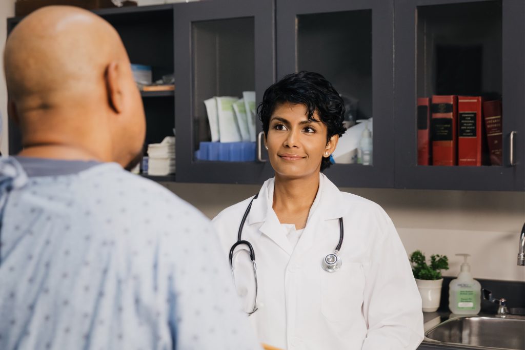 Patient looking at a doctor in a white coat.