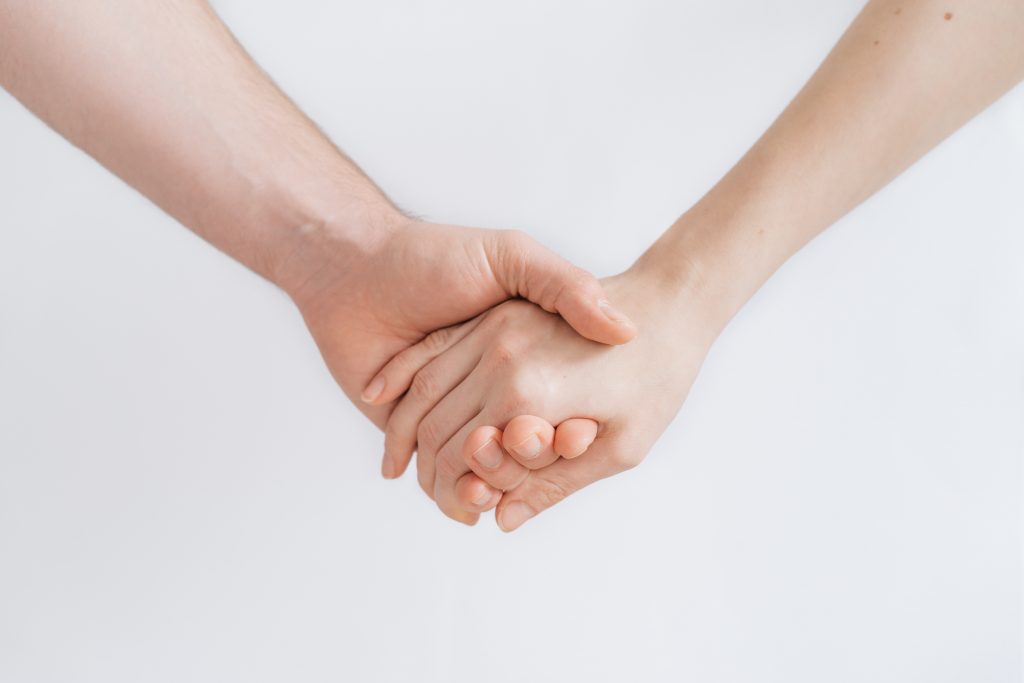 a pair of hands holding each other.