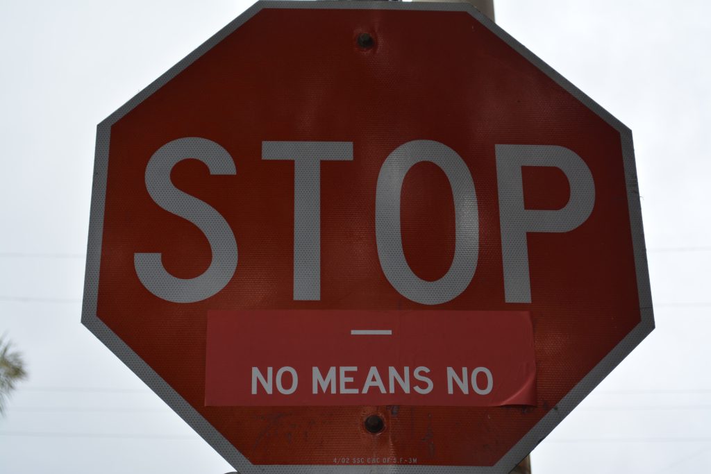 Red stop sign with "no means no" written below it.