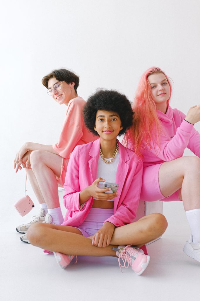 Three girls wearing pink clothing.