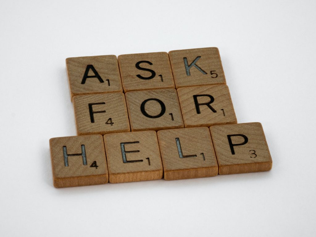 Wooden cubes spelling "ASK FOR HELP."