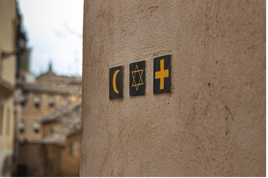 Crescent moon, star of David, and cross symbols on a wall