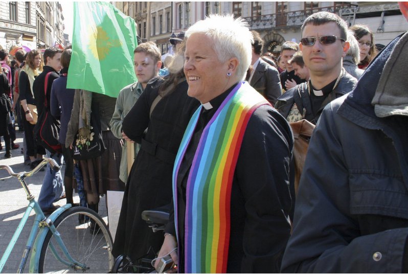 Priest wearing rainbow stripped stole 