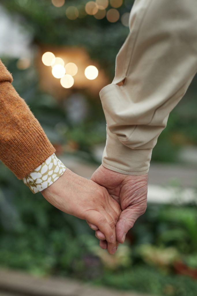 A close-up view of a couple holding hands.