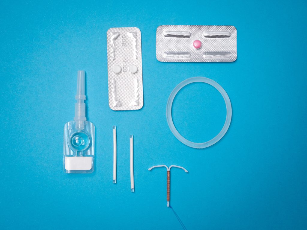 A variety of contraceptives including: the pill, a vaginal ring, an intrauterine device, and the arm implant.