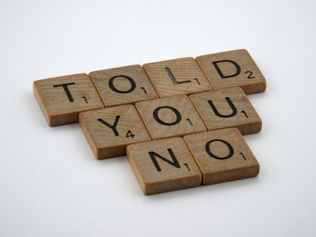 "TOLD YOU KNOW" spelled out on wooden blocks.