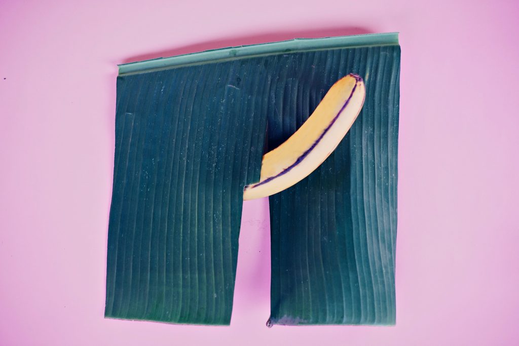 An erect banana coming out of green pants.