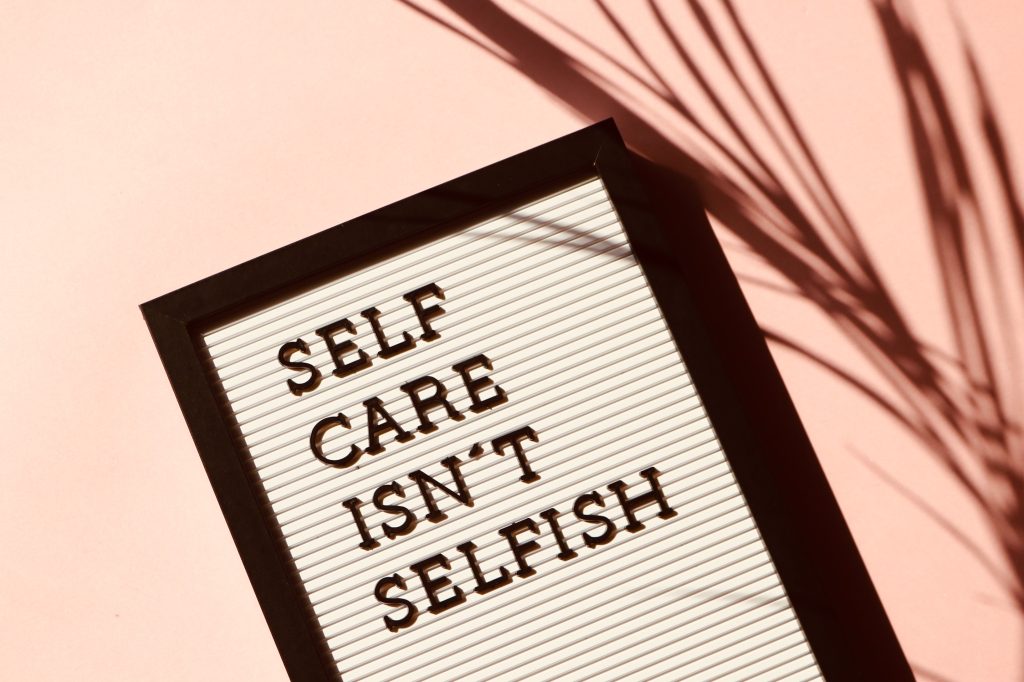 A sign that says "self care isn't selfish."