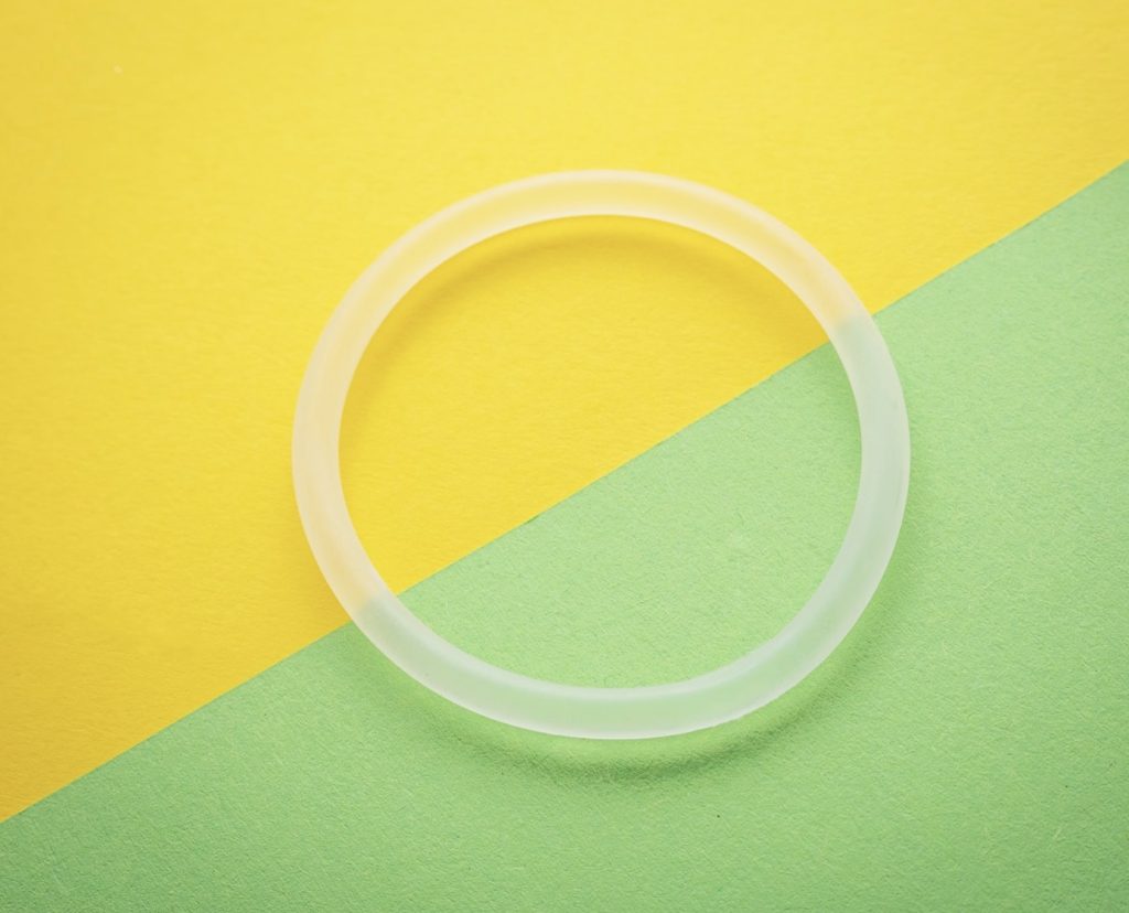 clear plastic ring on green and yellow background