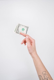 A person holding up money.