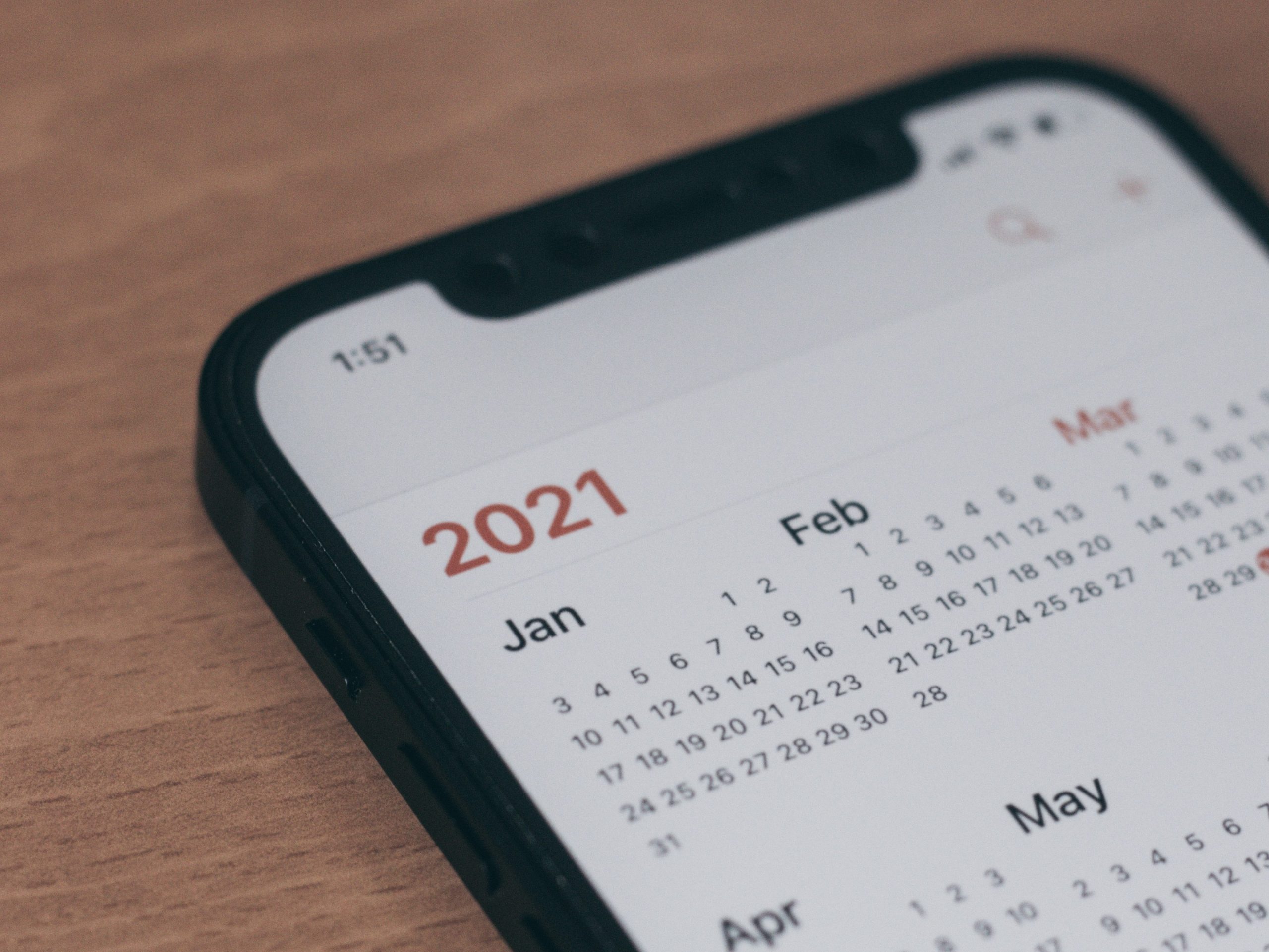 Phone with a calendar app opened to a page showing all of the months of the year 2021.