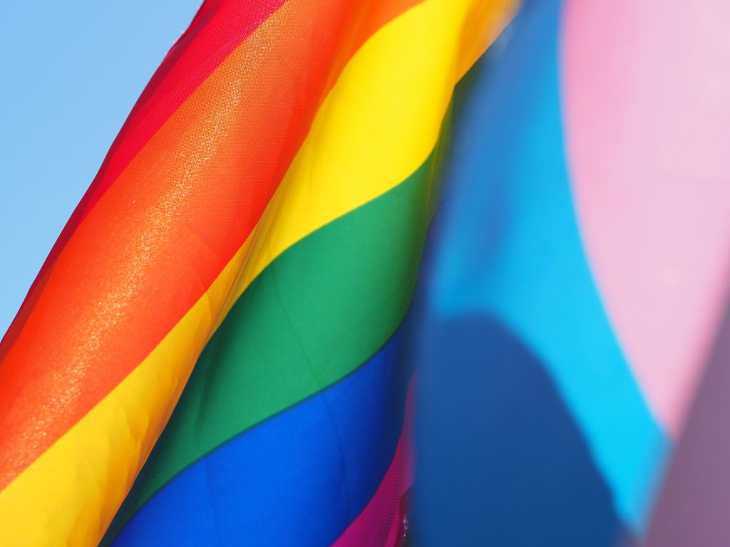 Rainbow pride flag next to trans flag