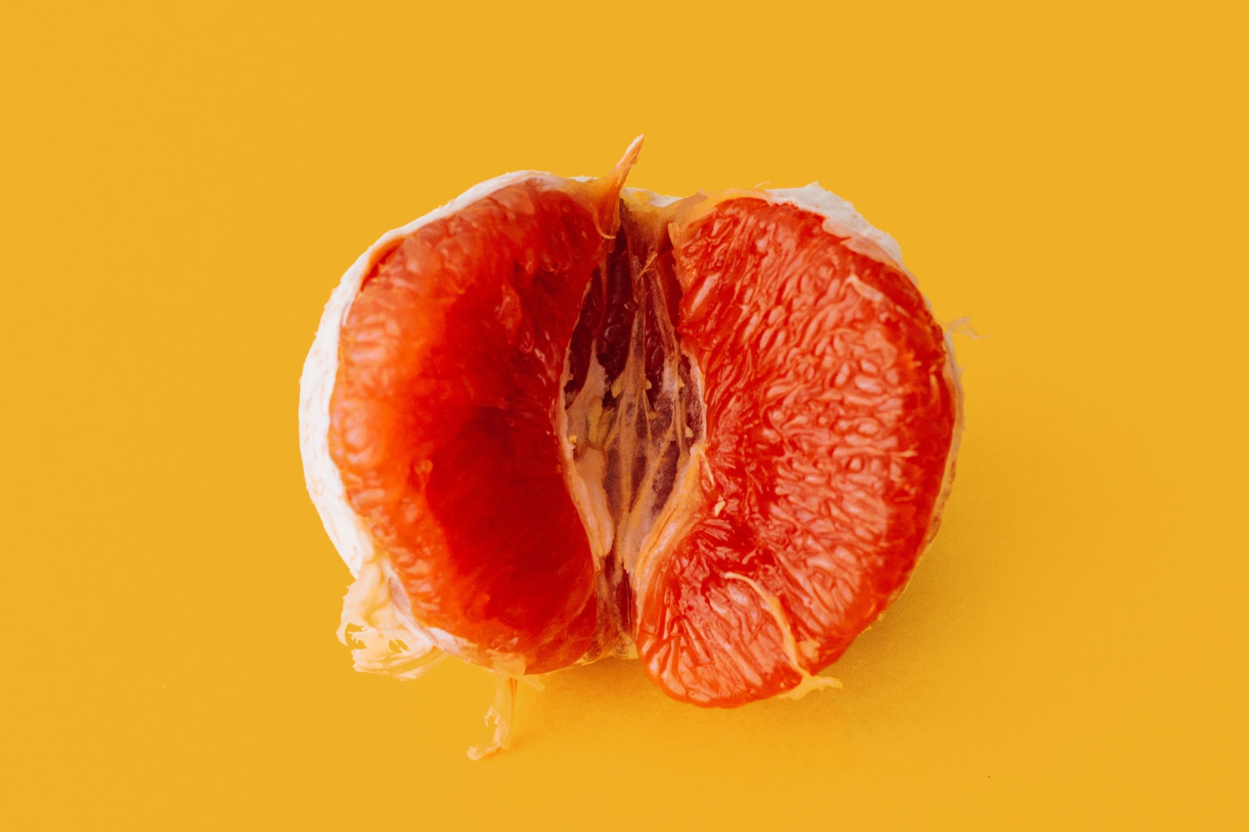 A peeled tangerine split in half.