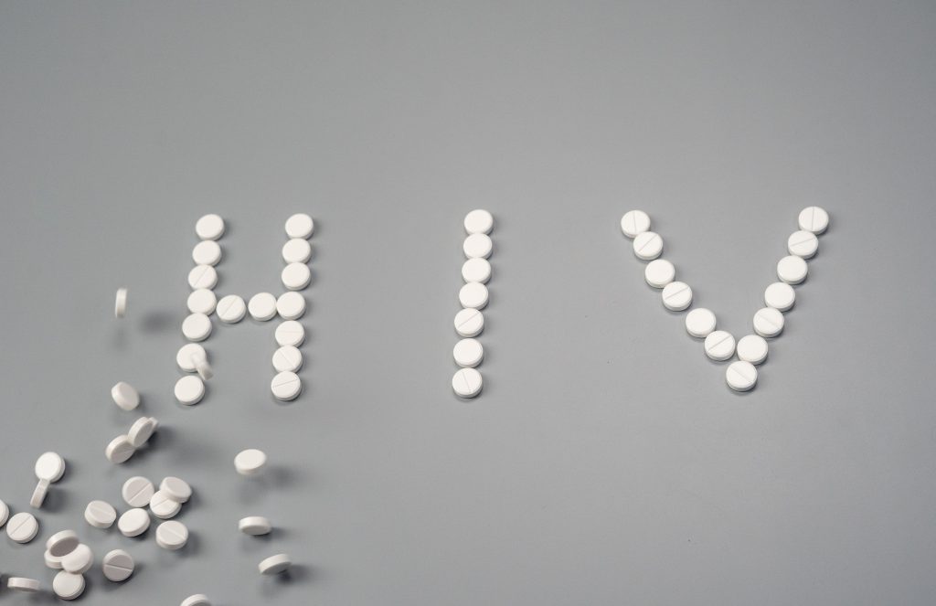 HIV spelled out with white pills.