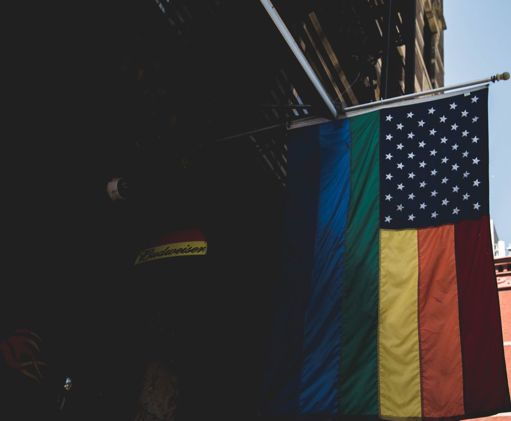 American flag displaying the rainbow stripes of the Pride flag.