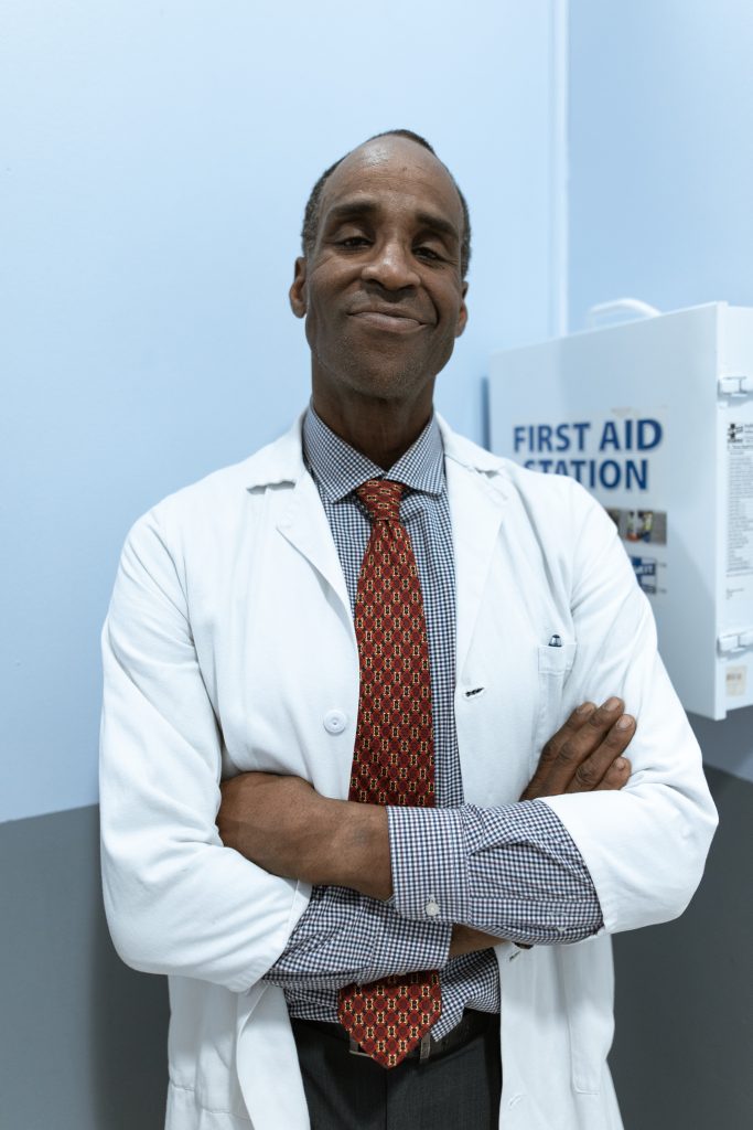 Smiling doctor with arms crossed