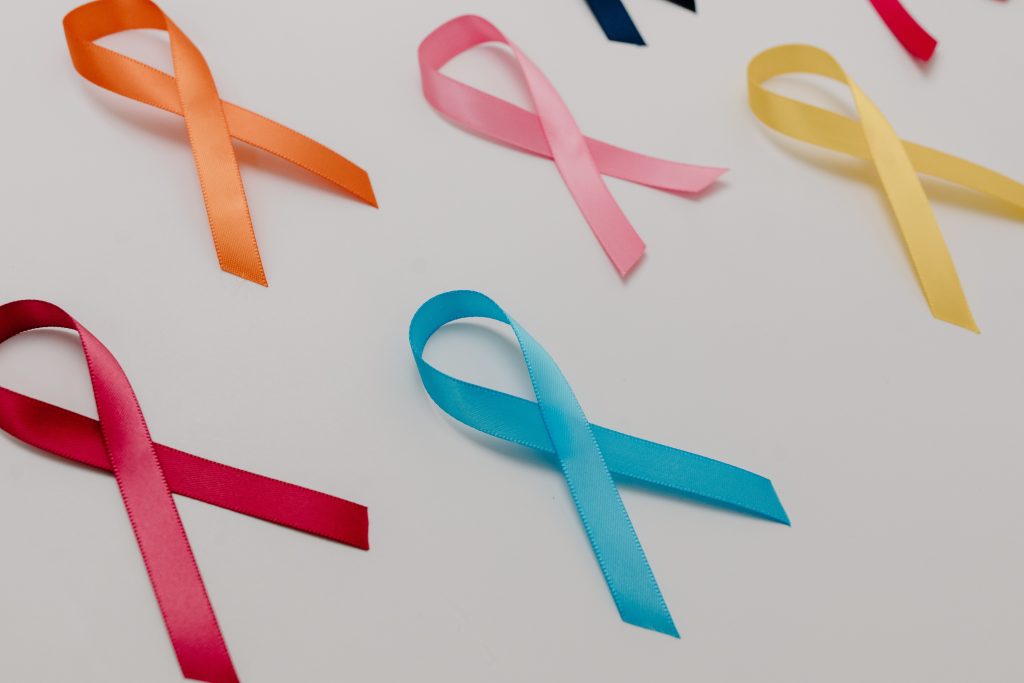 Variety of cancer awareness ribbons with the light blue for prostate cancer ribbon around the center of the frame